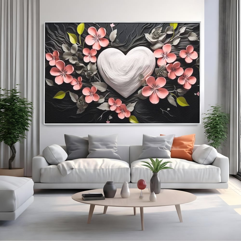 Tablou canvas cu tablou canvas cu inima alba si flori roz, in rama de aluminiu argintiu, pe perete intr-un living